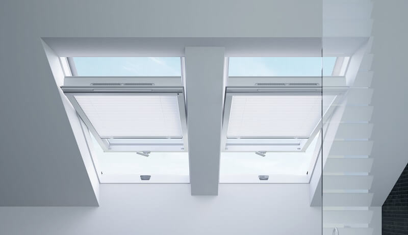 Two side by side open roof windows in a bathroom